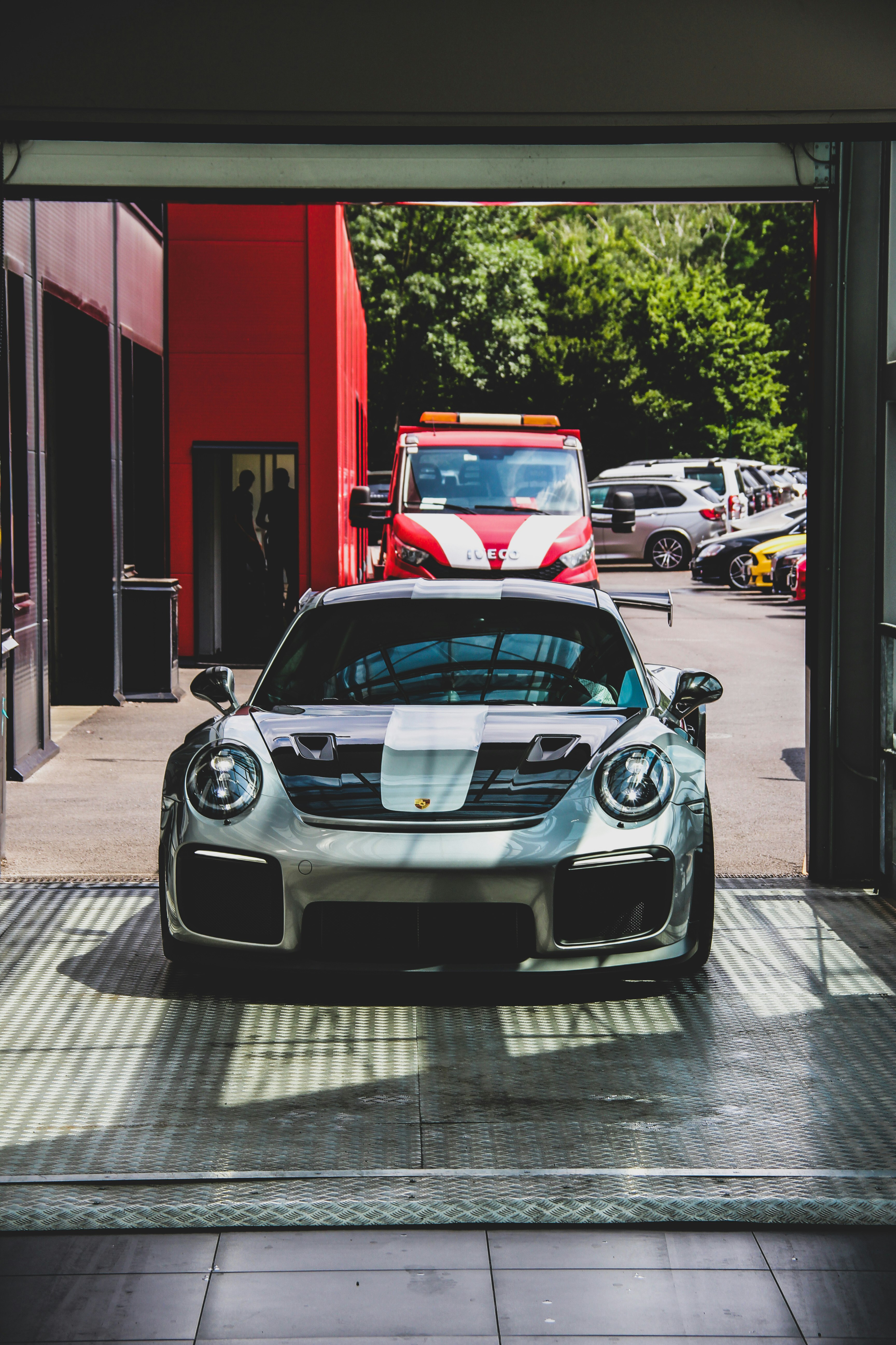 silver Porsche Carrera sports car on pavement